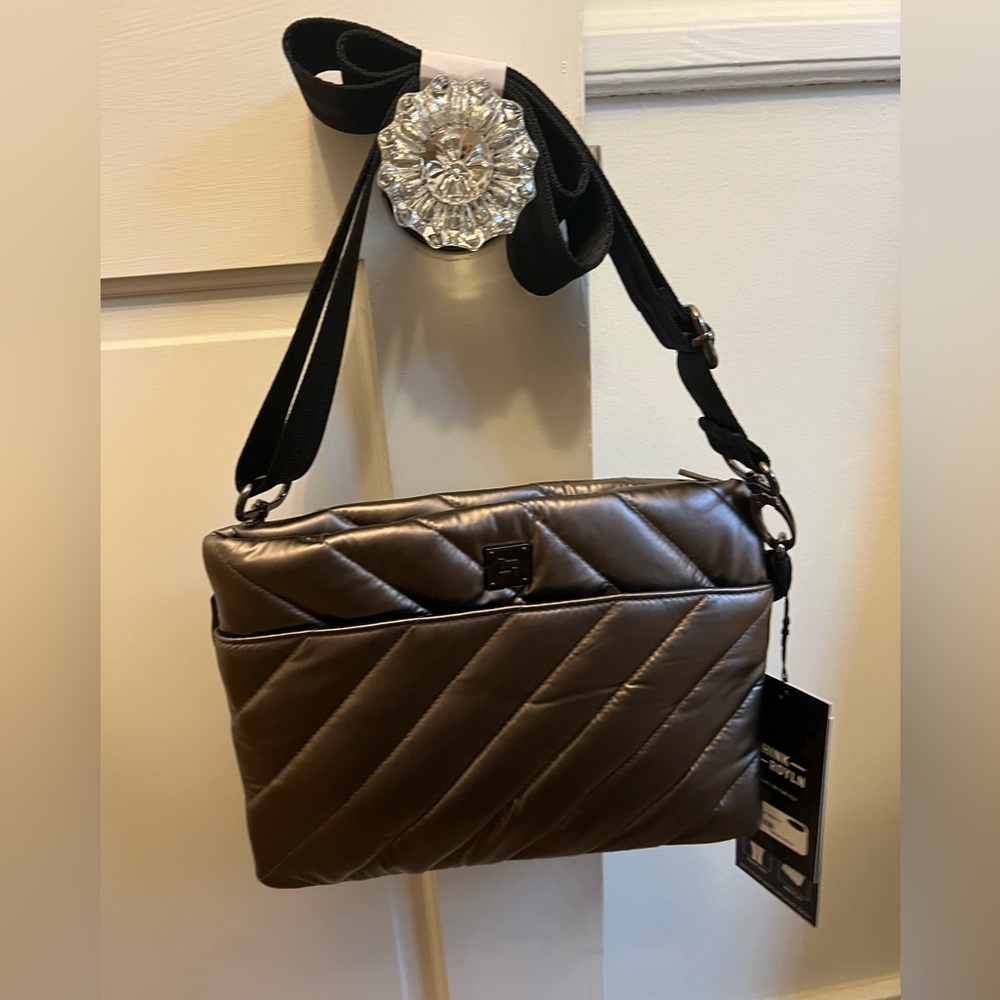 Never worn crossbody bag. Multiple pockets and extra strap inside